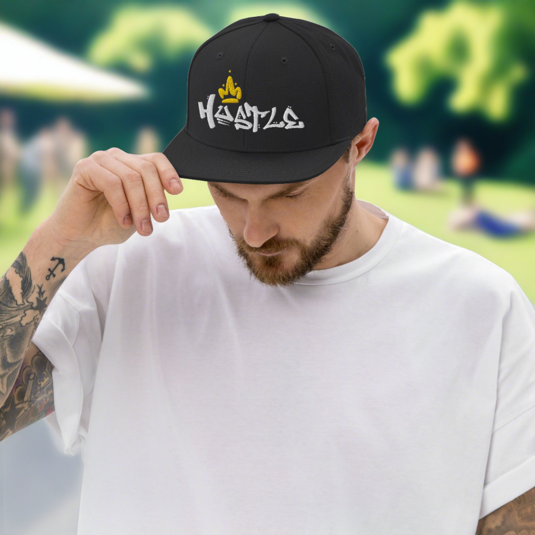 A young man in the park wearing a black Hustle King Theme snapback hat. Hats – Shop Stylish Hats for Men and Women