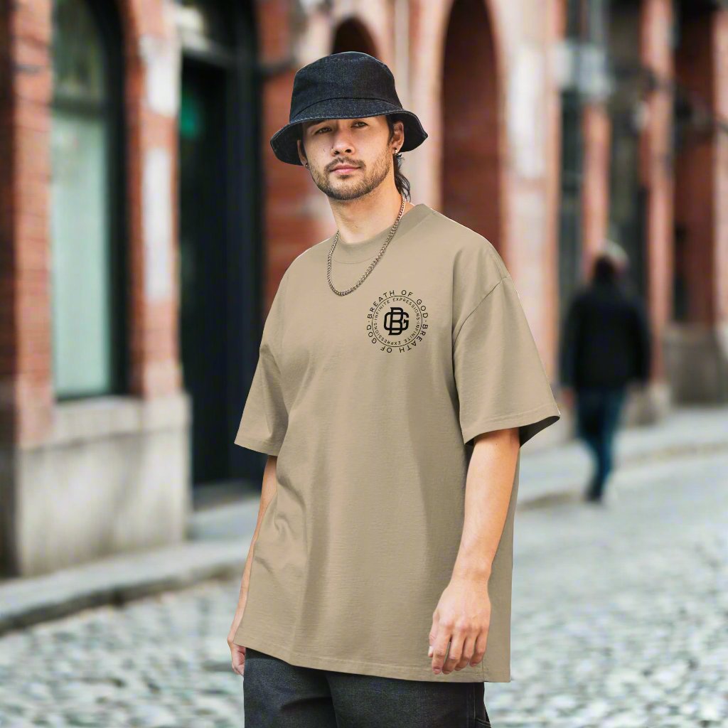 A lifestyle mockup of an urban man wearing the Breath Of God Concept Tee, front view.