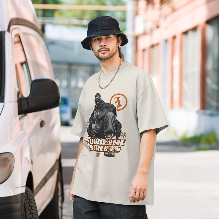 A lifestyle mockup of an urban man wearing the Men's I Own The Streets Theme Oversized Faded Tee, front view.
