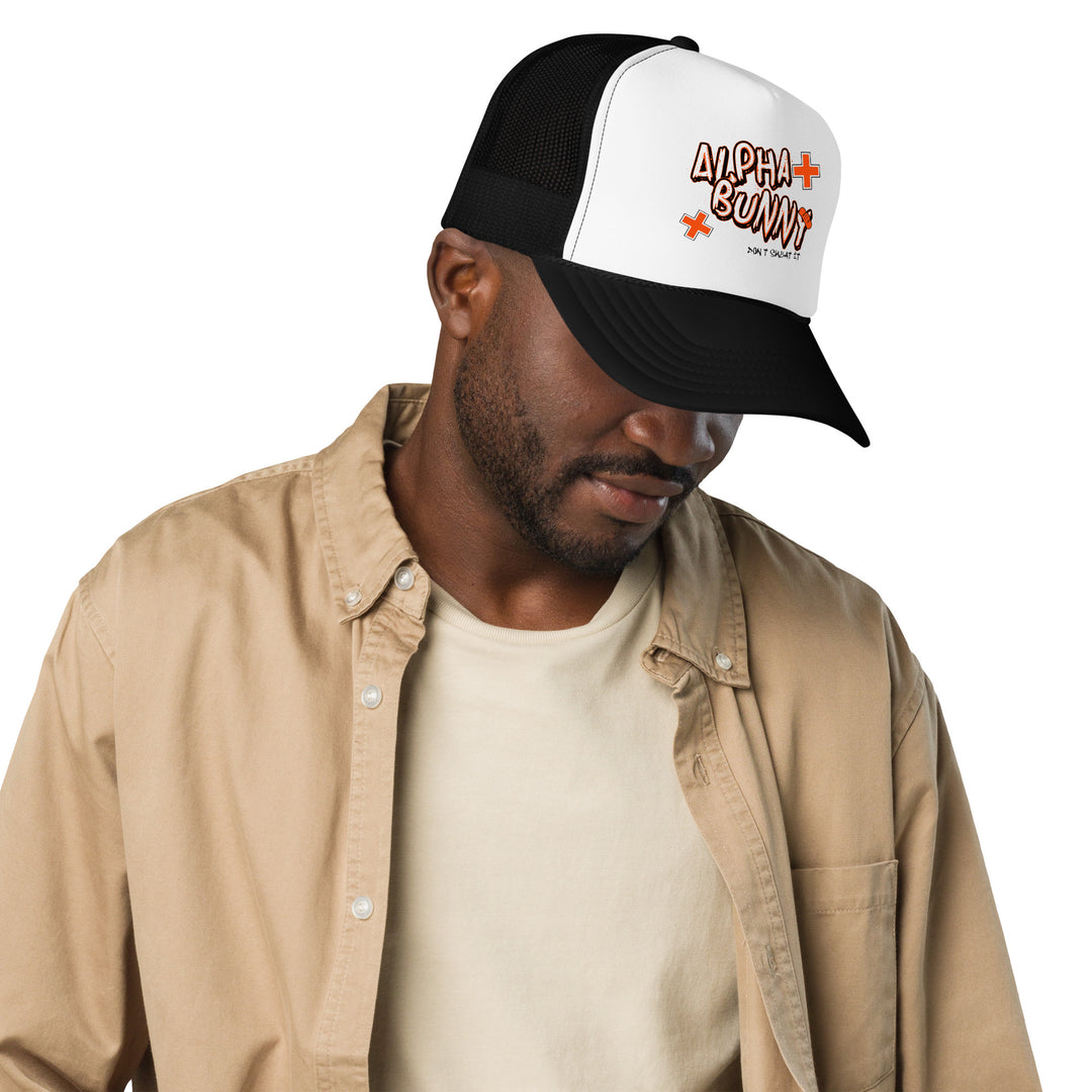 A modern young man is wearing the Alpha Bunny Foam Trucker Hat, front view.
