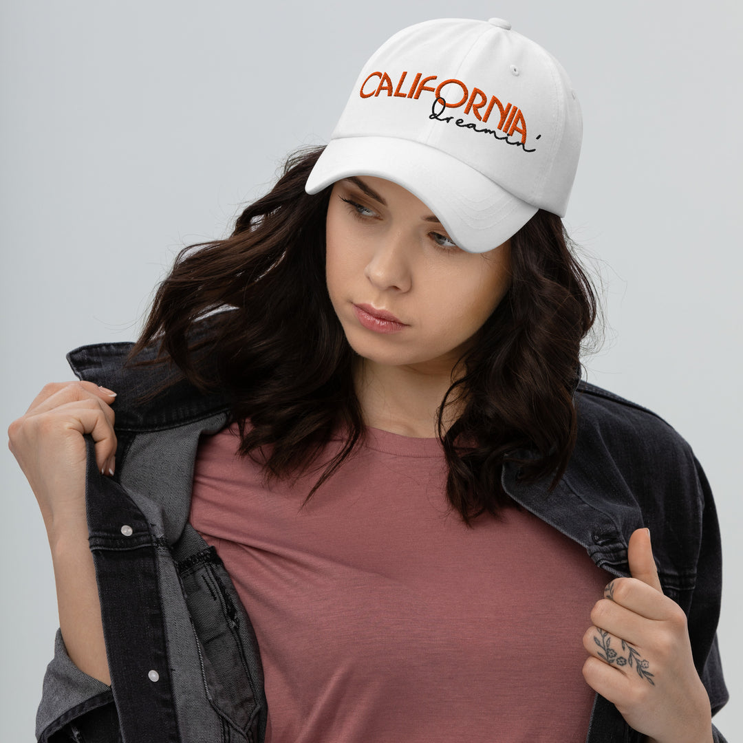 A modern young woman is wearing the California Dreamin' Dad Hat, front view.