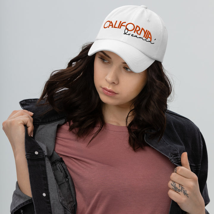 A modern young woman is wearing the California Dreamin' Dad Hat, front view.