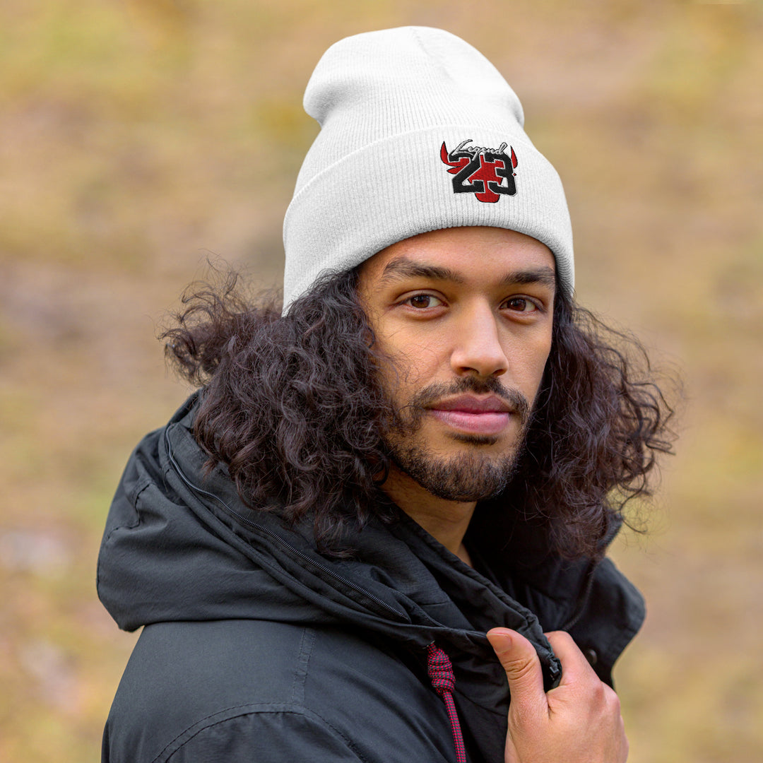 A young man wearing a jacket is wearing the Legend 23 And Tribute Embroidered Cuffed Beanie, front view.