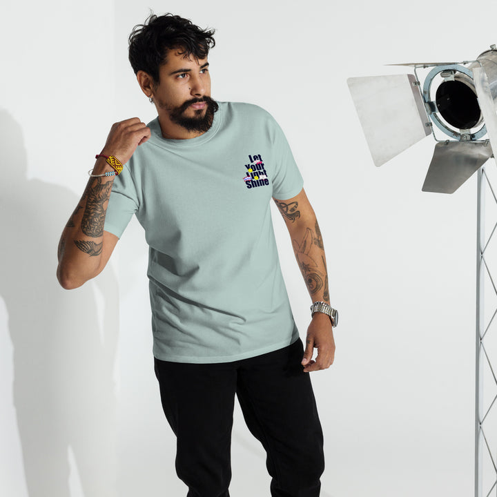 An urban man in the studio is wearing the Let Your Light Shine Premium Tee, front view.