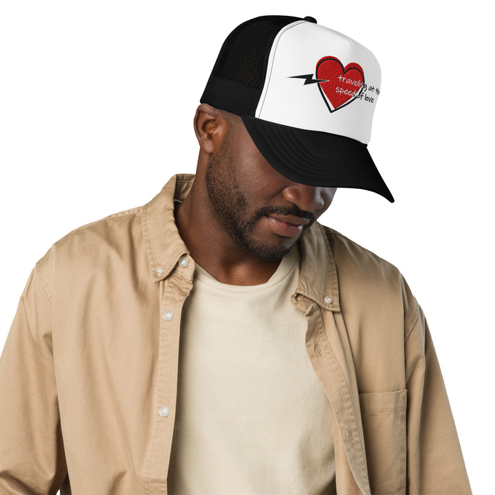 An urban man is wearing the Love Theme And Graphic Embroidered Foam Trucker Hat, front view.