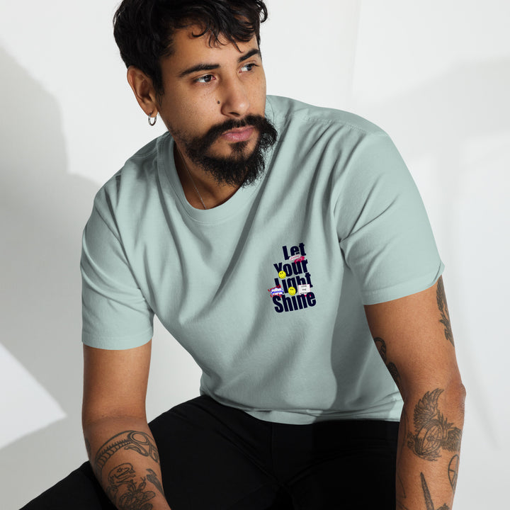 An urban man sitting in the studio is wearing the Let Your Light Shine Premium Tee, front view.
