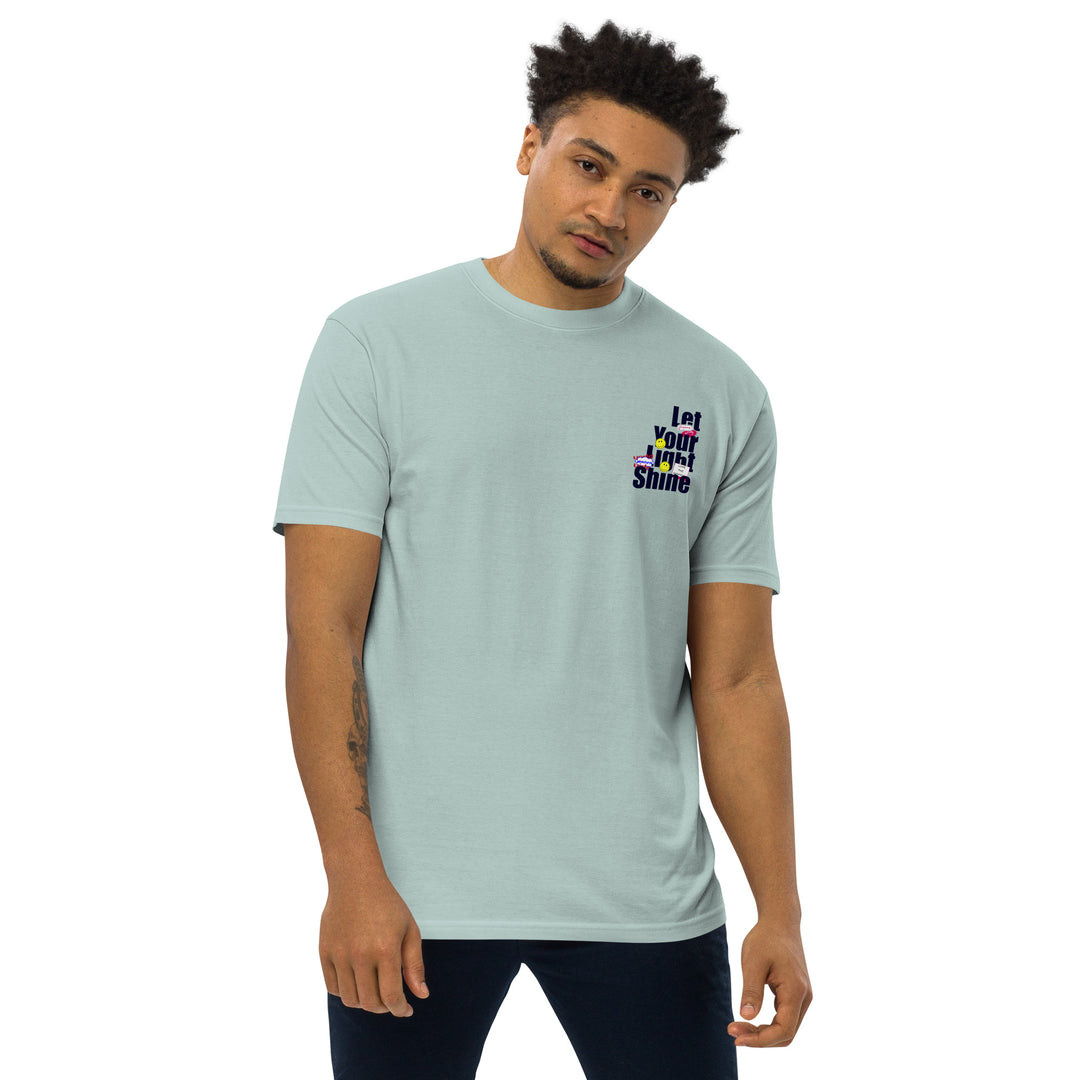 An urban man is wearing the Men’s Let Your Light Shine Premium Tee, front view.