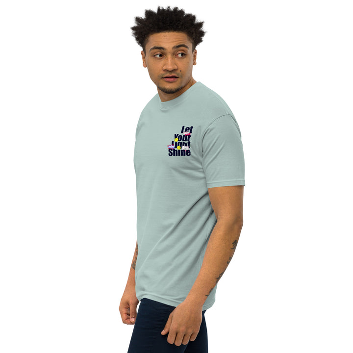 An urban man is wearing the Men’s Let Your Light Shine Premium Tee, front left view.